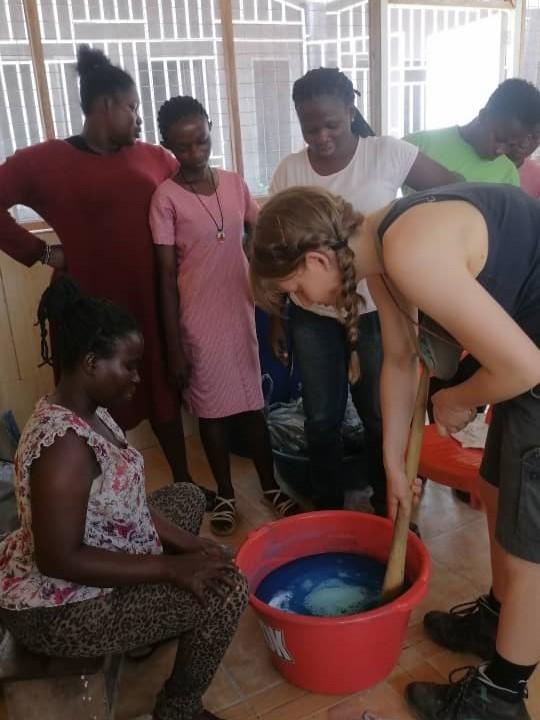 guest of bwo hostel is helping with the production of a fresh batch of liquid soap